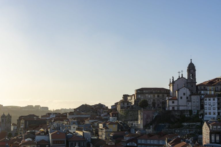 View to the historical part of the city of Porto (Portugal). Sunset and sky with clouds.
