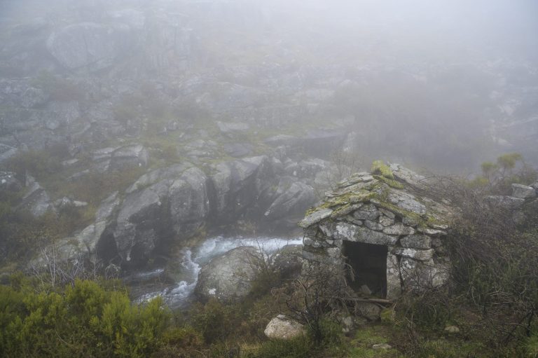 Old stone water mill. Mountain fresh water stream. Foggy day. Freita mountain range. Portugal